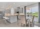 Open-concept kitchen with island, breakfast nook, and gray cabinets at 4507 Terrazza Ct, Bradenton, FL 34211