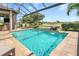 Private pool area with screened enclosure, comfortable seating, and outdoor kitchen at 4507 Terrazza Ct, Bradenton, FL 34211