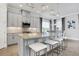 Modern kitchen with gray cabinets, granite countertops, and stainless steel appliances at 4507 Terrazza Ct, Bradenton, FL 34211