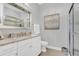 Elegant bathroom with granite countertop, white cabinets, and a large mirror at 4507 Terrazza Ct, Bradenton, FL 34211