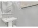Modern powder room with pedestal sink and gray walls at 4507 Terrazza Ct, Bradenton, FL 34211