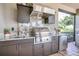 Luxury outdoor kitchen with stainless steel appliances and granite countertops at 4507 Terrazza Ct, Bradenton, FL 34211