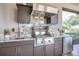 Outdoor kitchen with stainless steel appliances and granite countertops at 4507 Terrazza Ct, Bradenton, FL 34211