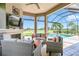 Relaxing lanai with pool view, wicker furniture, and fireplace at 4507 Terrazza Ct, Bradenton, FL 34211