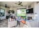 Outdoor living area with seating and a fireplace, plus a kitchen at 4507 Terrazza Ct, Bradenton, FL 34211