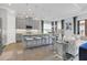 Open-concept kitchen with island, gray cabinets, and breakfast bar at 4507 Terrazza Ct, Bradenton, FL 34211