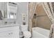 Modern bathroom with white vanity, bathtub, and patterned shower curtain at 4507 Terrazza Ct, Bradenton, FL 34211