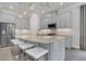 Modern kitchen with gray cabinets, granite countertops, and stainless steel appliances at 4507 Terrazza Ct, Bradenton, FL 34211