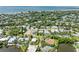 An aerial view of the neighborhood featuring waterfront homes, landscaping, and bay views at 136 Crescent Dr, Anna Maria, FL 34216