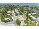 An aerial view showcasing the neighborhood homes and waterfront access to a canal and the ocean at 136 Crescent Dr, Anna Maria, FL 34216