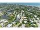 Aerial view showcasing a charming neighborhood with well-maintained homes, mature trees, and waterfront access at 136 Crescent Dr, Anna Maria, FL 34216