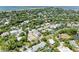 An aerial view of the neighborhood with lush landscaping, canal and gulf views at 136 Crescent Dr, Anna Maria, FL 34216
