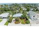 Aerial view of a charming home surrounded by lush landscaping and mature trees at 136 Crescent Dr, Anna Maria, FL 34216