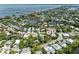 Aerial view of neighborhood showcasing a mix of homes with waterfront canals and landscaping at 136 Crescent Dr, Anna Maria, FL 34216
