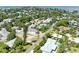 Aerial view of a waterfront neighborhood with mature trees, lawns and lush landscaping at 136 Crescent Dr, Anna Maria, FL 34216