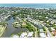 Aerial shot of canal-front homes with private docks, lush greenery, and bay views at 136 Crescent Dr, Anna Maria, FL 34216