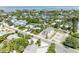 An aerial view of the property with well maintained landscaped yard and a neighborhood with waterfront properties at 136 Crescent Dr, Anna Maria, FL 34216
