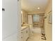 Bright bathroom featuring granite countertops, a tiled shower, and updated fixtures at 136 Crescent Dr, Anna Maria, FL 34216
