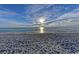 Picturesque sunset over a sandy beach, offering a tranquil and scenic view, with cloud-streaked blue skies at 136 Crescent Dr, Anna Maria, FL 34216