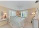 Charming bedroom with coastal decor, plantation shutters, and a ceiling fan at 136 Crescent Dr, Anna Maria, FL 34216