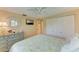 Cozy bedroom featuring a ceiling fan, coastal decor, ample storage, and natural light from windows at 136 Crescent Dr, Anna Maria, FL 34216