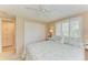 Comfortable bedroom with a ceiling fan, ample closet space, and coastal decor at 136 Crescent Dr, Anna Maria, FL 34216