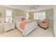 Inviting bedroom with a ceiling fan, plantation shutters, and coastal-themed decor at 136 Crescent Dr, Anna Maria, FL 34216