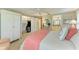 Well-lit bedroom showcasing a closet, view to the en suite bath, and coastal decorations at 136 Crescent Dr, Anna Maria, FL 34216