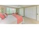Bright bedroom with plantation shutters, a ceiling fan, and ample closet space at 136 Crescent Dr, Anna Maria, FL 34216