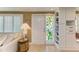 Inviting entryway featuring a decorative door with side-light window and built-in shelving at 136 Crescent Dr, Anna Maria, FL 34216