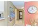 Hallway with wall art and mirror leading to rooms at 136 Crescent Dr, Anna Maria, FL 34216