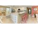 Spacious kitchen with breakfast bar, stainless steel appliances, and seamless flow to dining and living areas at 136 Crescent Dr, Anna Maria, FL 34216