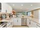 Well-lit kitchen with granite countertops and stainless steel appliances at 136 Crescent Dr, Anna Maria, FL 34216