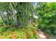 Lush tropical landscaping and stone pathway leading to the home at 136 Crescent Dr, Anna Maria, FL 34216