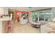 Spacious living room with sliding glass doors to an outdoor dining area at 136 Crescent Dr, Anna Maria, FL 34216