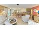 Bright living room flowing into the kitchen and dining area, great for entertaining at 136 Crescent Dr, Anna Maria, FL 34216