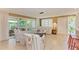 Open living room featuring a large sofa, chairs, and access to the patio at 136 Crescent Dr, Anna Maria, FL 34216