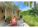 Relax on this patio with lush landscaping, an outdoor shower and a comfortable Adirondack chair at 136 Crescent Dr, Anna Maria, FL 34216