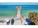 Charming pier view with a waterfront restaurant, golf carts, and bicycles, perfect for beachside leisure at 136 Crescent Dr, Anna Maria, FL 34216