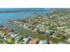 Aerial view of waterfront property with lush landscaping and private dock at 1833 Sandalwood Dr, Sarasota, FL 34231