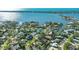 Aerial view of waterfront property with lush landscaping and private dock at 1833 Sandalwood Dr, Sarasota, FL 34231