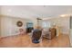 Living room with hardwood floors, comfortable seating, and a large TV at 1833 Sandalwood Dr, Sarasota, FL 34231