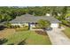 Single-story home with a gray roof, landscaped yard, and driveway at 1833 Sandalwood Dr, Sarasota, FL 34231