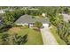 Single-story home with gray roof, well-maintained lawn, and driveway at 1833 Sandalwood Dr, Sarasota, FL 34231