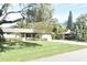 Single story home with a well-maintained lawn and driveway at 1833 Sandalwood Dr, Sarasota, FL 34231