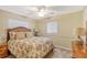 Bedroom with floral bedding and ceiling fan at 1833 Sandalwood Dr, Sarasota, FL 34231