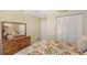 Bedroom with floral bedding and wooden dresser at 1833 Sandalwood Dr, Sarasota, FL 34231