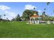 A sunny view of the gazebo with a red roof in a park at 19369 Nearpoint Dr, Venice, FL 34292