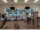 Community gym with treadmills, bikes and weights in front of large windows overlooking the community pool at 19369 Nearpoint Dr, Venice, FL 34292