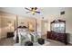 Spacious bedroom with a post bed, two armchairs, and a dresser at 2825 Terra Ceia Bay Blvd. # 1202, Palmetto, FL 34221